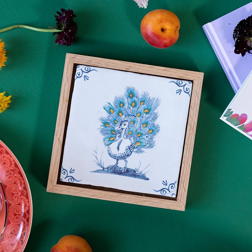 Tegellijst met pauw-illustratie op groene ondergrond Groenten